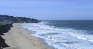 ocean waves at beach with blue skies overhead