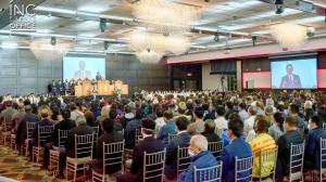 Crowd gathered with the Iglesia Ni Cristo at Aria Convention Centre in Surrey, BC, Canada while facing podium where Minister of the gospel, Moriel Cadacio stands giving a message of hope based on the Bible