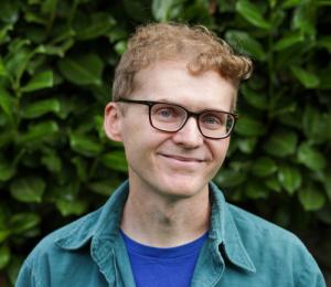 A headshot of author Joshua James Amberson