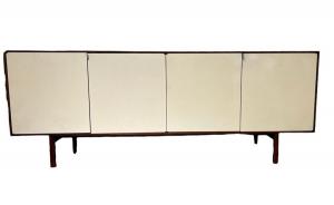 Florence Knoll walnut and laminate credenza (circa 1960s-‘70s), the walnut top and sides over four hinged off-white laminate doors with chrome pulls (est. $1,500-$3,000).
