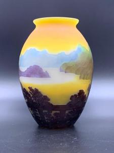Galle cameo glass scenic vase of baluster form with an everted lip, the gray glass walls overlaid in multiple colors, with view of a mountain lake landscape (est. $1,000-$2,000).