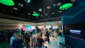 A crowd of people around the ECMWF booth at the Living Planet Symposium.
