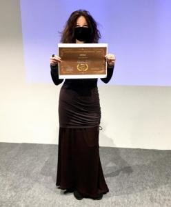 Beautiful woman holding an Award Certificate