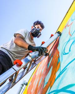 Muralist Effe creating for The Outlaw Ocean Mural Project