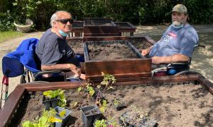 David S. and Lawrence K., residents of Alden Terrace of McHenry, prepare their new raised garden beds for planting.