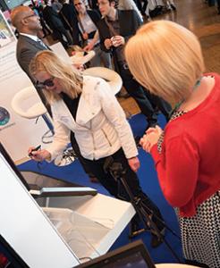 Attendees gather around an exhibition stand at a previous NAFEMS World Congress