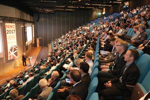 Attendees in a packed auditorium listen to a presentation at a previous NAFEMS World Congress