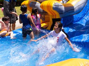 Youngsters barreled down the inflatable slide and into the water, and the younger set splashed in the wading pool set up on L. Ron Hubbard Way.
