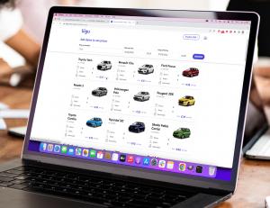 Screenshot of Liigu's new rental booking system, which shows Liigu's cars in a grid is open in a laptop at an office.