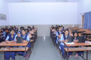 Girl Students using Tabs provided by Ashraya at a school in Madhya Pradesh.