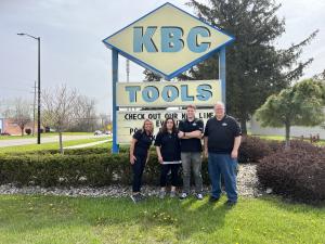 Picture of KBC Team in front of the building's signage.