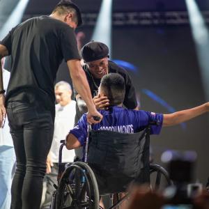 Ronaldinho abraza a un aficionado en silla de ruedas