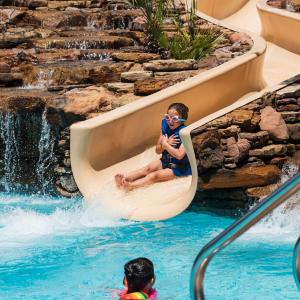 child on pool slide