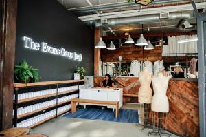 woman sitting at Los Angeles clothing manufacturer's desk