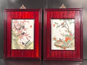 Pair of framed Chinese porcelain plaques painted with seasonal themes of birds and flowering trees, each one 19 ¼ inches tall (est. $100-$300).