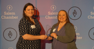 Courtney Marti, Vice President of Marketing and Julee Engelsman, Lead TMS Technician at Active Recovery TMS, two middle aged women standing and holding their award