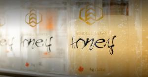 Genuhoney-certified pure raw honey being packaged fresh on the farm