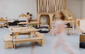 children running in classroom with wooden educational furniture made from wood, recycled chopsticks and reclaimed heritage lumber.