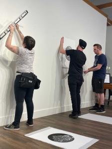 Arts Visalia Gallery staff working on setting up exhibit