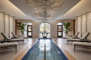 multimillion-dollar renovation and expansion features a tranquil indoor float pool for resting and relaxing, as well as custom branchlike chandeliers dripping with crystal water drops and outdoor pool views.