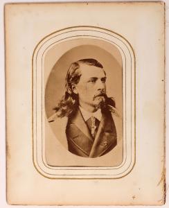 Early carte de visite photograph of Buffalo Bill Cody in his younger years, circa 1870s, made by the Theatrical Photography Company, housed in a 4 inch by 5 inch frame (est. $20,000-$50,000).