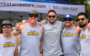 group of five men wearing grey shirts with 5 star logo