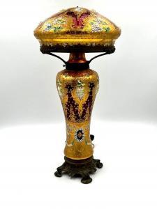 Lovely circa 1930 Moser cranberry glass enameled lamp with domed shade enameled in gilding and applied with sculpted enamel flowers, 25 inches tall (est. $4,000-$6,000).