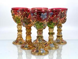 Set of six Moser enameled glass wines with applied decoration in ruby glass, with faceted bowls on shaped stems, applied with relief molded grapes and leaves (est. 2,000-$4,000).
