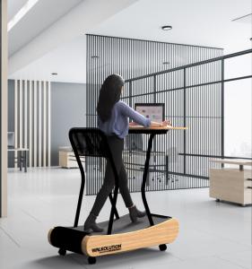 Woman uses a Walkolution treadmill desk in a corporate office