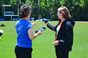 Skydio's Mira Marquez (on left) helps STEM camp participants understand Drone flight dynamics.