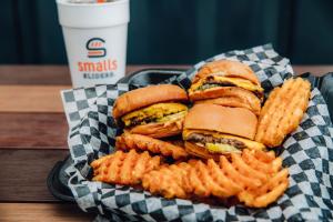Smalls Sliders serves cheeseburger sliders, seasoned waffle fries and shakes
