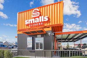 Smalls Sliders Building is a c-can design with bright orange accents.