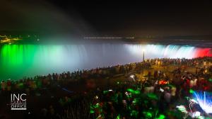 Niagara Falls at night with green, white and red colors illuminated