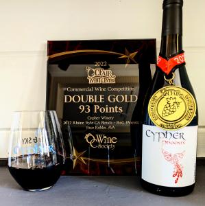 Bottle of Cypher Phoenix with Double Gold Medal around neck of bottle and Double Gold Honorary Plaque in background.