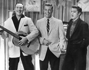 Wink Martindale and Elvis Presley share a moment onstage during 'Top Ten Dance Hour' in 1954.