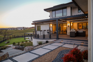 backyard with synthetic turf, steppers, pool and outdoor kitchen