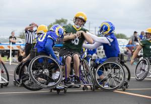 Two weelchair football teams competing on the field