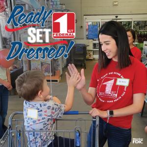 Ready Set Dressed shopper gives First Federal Bank volunteer high five