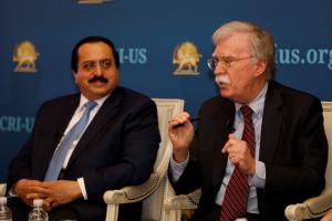 Alireza Jafarzadeh listens to Ambassador John Bolton as he describes the first time the U.S. Government heard about the Natanz revelation in 2002.