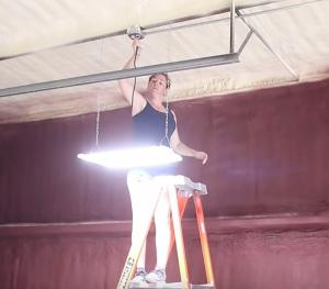 April Wilkerson installing a PLT Solutions LED High Bay