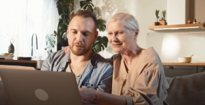 Mother and son discussing Alzheimer whilst looking at results on a computer screen