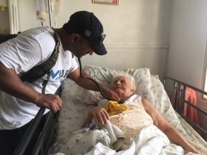 Dr. Naval Parikh tends to an elderly woman in Puerto Rico.