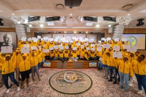 Over 100 different specialists cheerily pose for a group shot after being equipped with tools to handle life