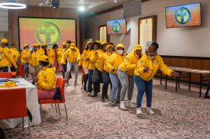 A group of graduates doing a celebratory dance to honor their achievements