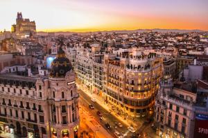 A drone shot of Madrid buildings during sunset