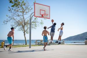 A group of young guys playing basketball