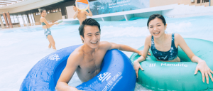 adult couple in the wave pool in inner tubes