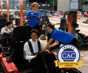Visalia Adventure Park staff helping a guest get strapped into the go kart