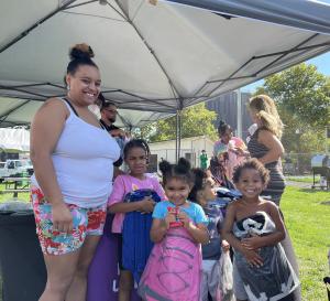 Children receive backpacks from Excelsior University for back-to-school