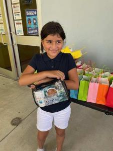 Embrace Girls Foundation member collects personal care items.